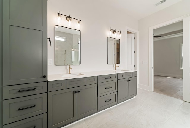 full bath with walk in shower, a sink, double vanity, baseboards, and visible vents