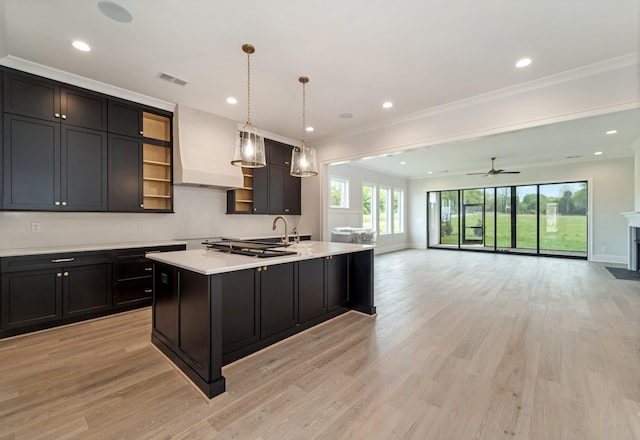 kitchen featuring visible vents, open shelves, custom exhaust hood, light wood-type flooring, and light countertops