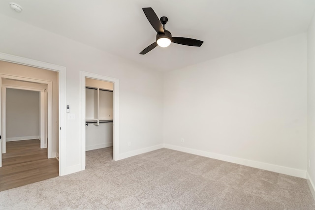 unfurnished bedroom featuring a closet, baseboards, carpet, and a ceiling fan