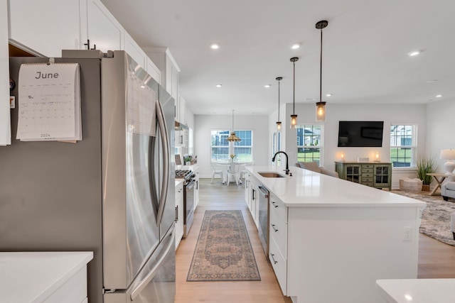 3012 Manchester Dr, Spring Hill, TN 37174 - kitchen featuring light wood-style floors, light countertops, white cabinetry, a sink, and appliances with stainless steel finishes