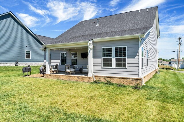 3012 Manchester Dr, Spring Hill, TN 37174 - rear view of house featuring a patio, outdoor lounge area, a lawn, and roof with shingles