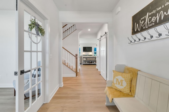 3012 Manchester Dr, Spring Hill, TN 37174 - corridor with light wood-style flooring, stairs, and a barn door