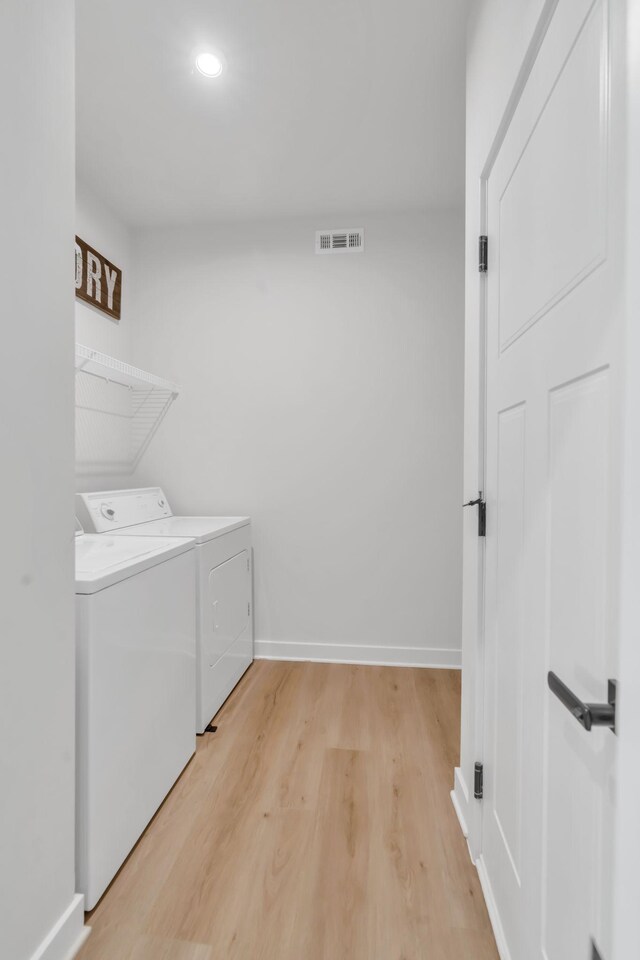 3012 Manchester Dr, Spring Hill, TN 37174 - clothes washing area with laundry area, baseboards, light wood-type flooring, visible vents, and washing machine and dryer
