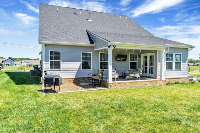 3012 Manchester Dr, Spring Hill, TN 37174 - rear view of property featuring a lawn, a shingled roof, a patio area, and central AC