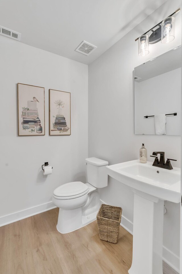 3012 Manchester Dr, Spring Hill, TN 37174 - half bath with baseboards, toilet, wood finished floors, and visible vents