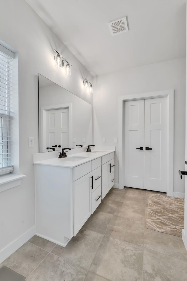 3012 Manchester Dr, Spring Hill, TN 37174 - full bathroom with double vanity, visible vents, a healthy amount of sunlight, and a sink