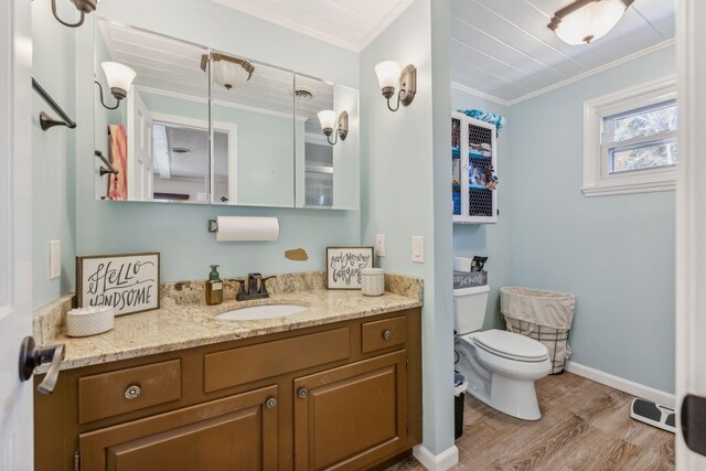 635 Cane Creek Rd, Hohenwald, TN 38462 - bathroom with vanity, ornamental molding, wood finished floors, toilet, and baseboards