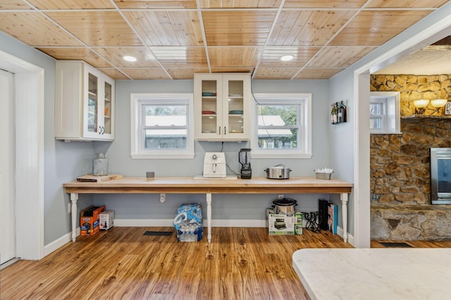 635 Cane Creek Rd, Hohenwald, TN 38462 - kitchen with white cabinetry, wooden ceiling, glass insert cabinets, and wood finished floors