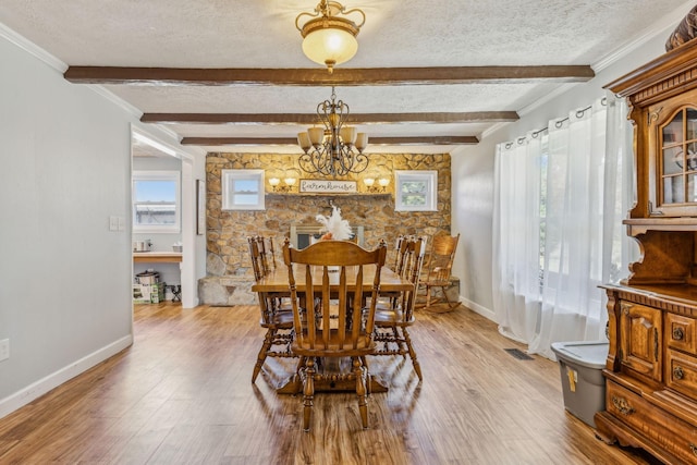 635 Cane Creek Rd, Hohenwald, TN 38462 - dining space with baseboards, light wood-type flooring, a textured ceiling, and a chandelier