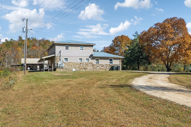 635 Cane Creek Rd, Hohenwald, TN 38462 - back of property with driveway, a yard, stone siding, and metal roof
