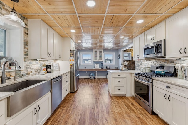 635 Cane Creek Rd, Hohenwald, TN 38462 - kitchen with white cabinets, a sink, stainless steel appliances, a peninsula, and wooden ceiling