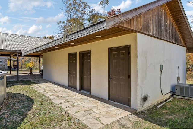 635 Cane Creek Rd, Hohenwald, TN 38462 - rear view of property with central AC unit and stucco siding
