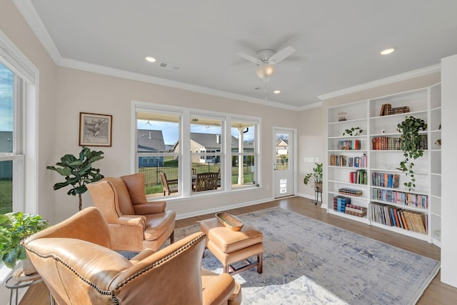 living area with visible vents, crown molding, wood finished floors, ceiling fan, and recessed lighting