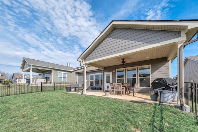 back of house with a yard, ceiling fan, a fenced backyard, and a patio area
