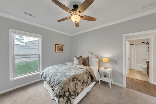 bedroom featuring crown molding, light colored carpet, baseboards, and visible vents