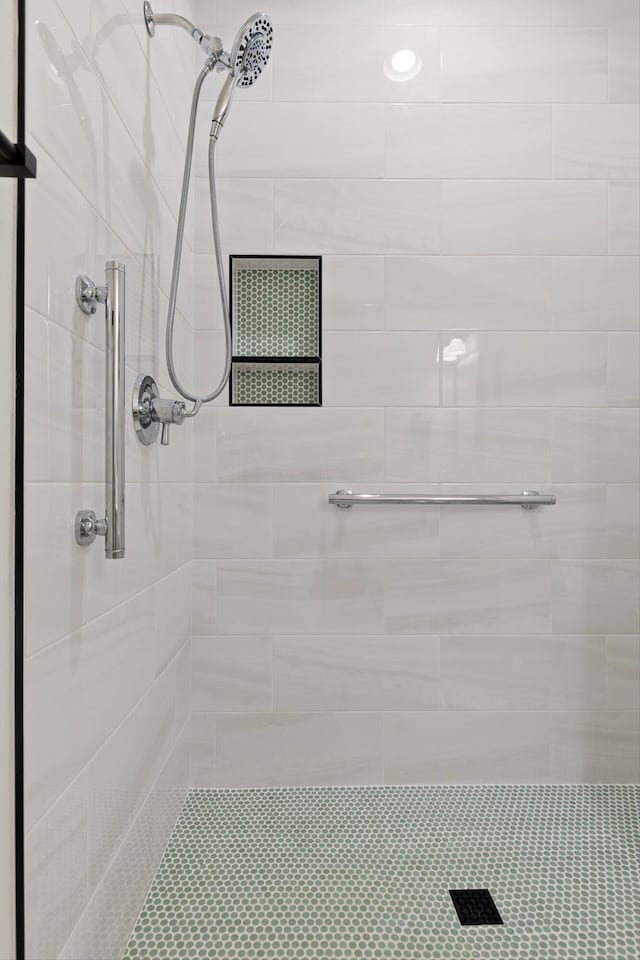bathroom with a tile shower