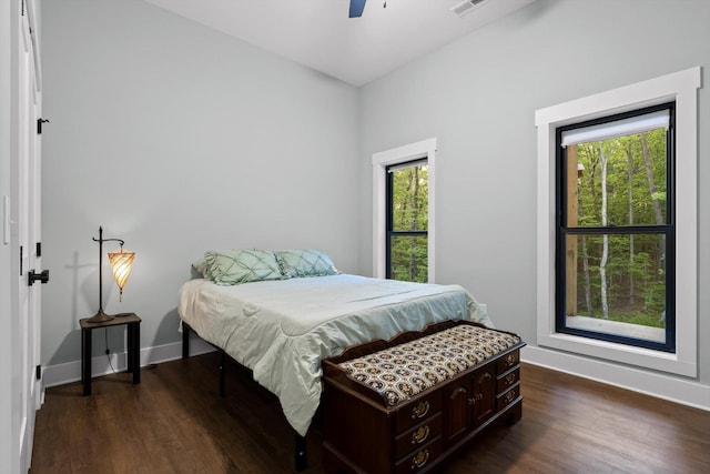 bedroom featuring baseboards, dark wood-style floors, and ceiling fan