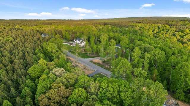 drone / aerial view featuring a forest view