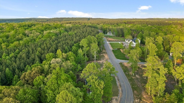 birds eye view of property with a view of trees