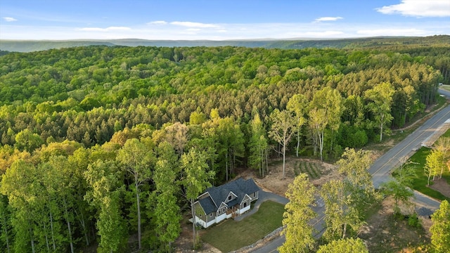 drone / aerial view featuring a water view and a view of trees