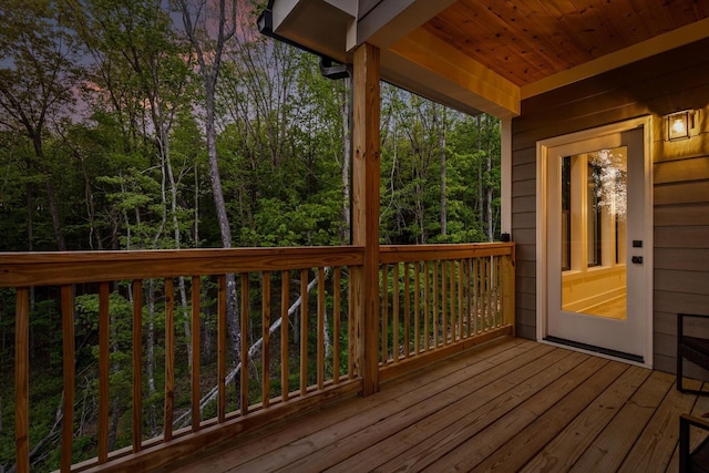 wooden deck with a forest view