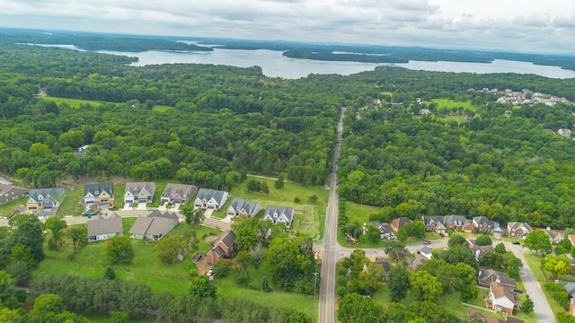 bird's eye view featuring a water view, a residential view, and a wooded view