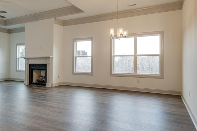 unfurnished living room with a fireplace, dark wood finished floors, baseboards, visible vents, and ornamental molding