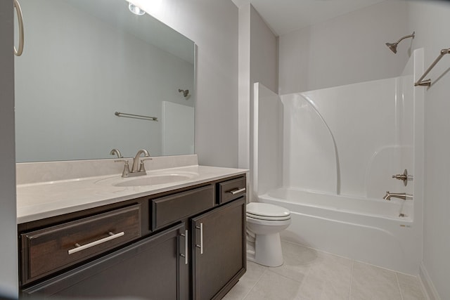 bathroom with vanity, washtub / shower combination, tile patterned floors, and toilet