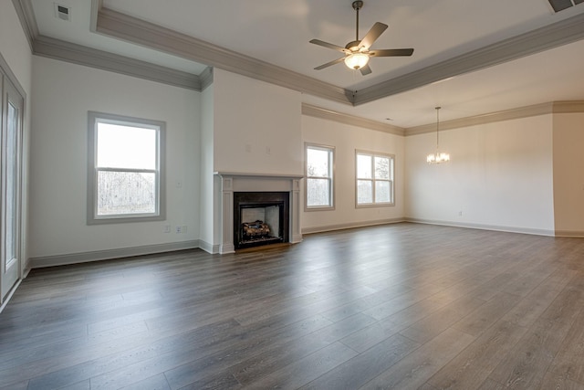 unfurnished living room with crown molding, a tray ceiling, a fireplace, and visible vents
