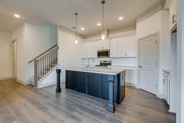 kitchen featuring a sink, stainless steel appliances, white cabinetry, and dark wood-type flooring
