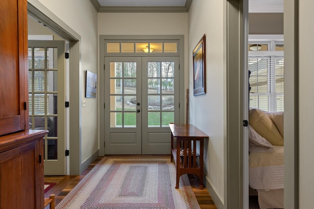 entryway featuring baseboards, ornamental molding, and french doors