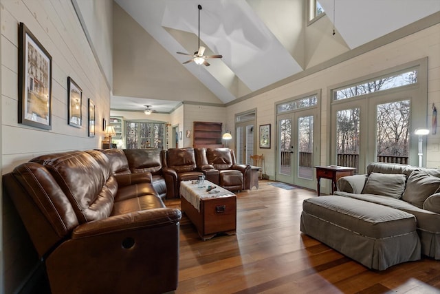 living room featuring high vaulted ceiling, ceiling fan, french doors, and wood finished floors