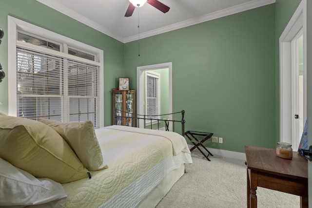 carpeted bedroom featuring baseboards, ornamental molding, and ceiling fan