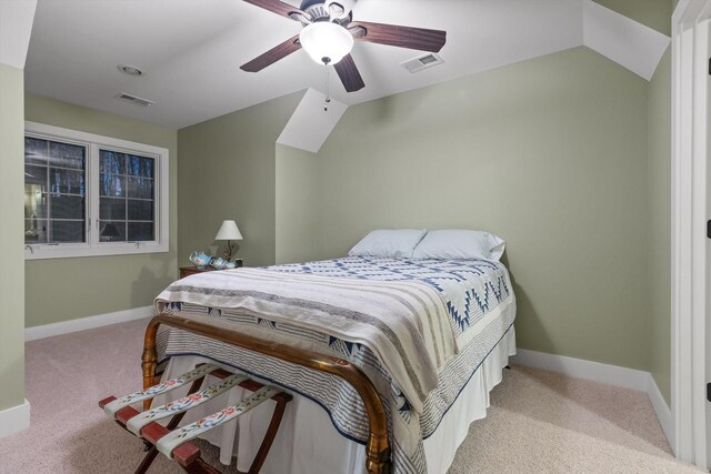 carpeted bedroom featuring a ceiling fan, baseboards, visible vents, and vaulted ceiling