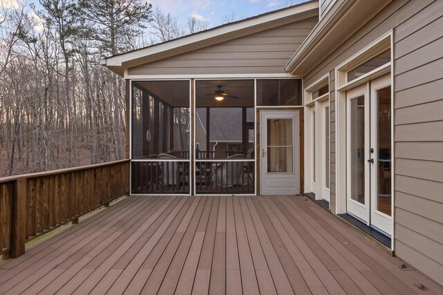wooden terrace with french doors and a sunroom