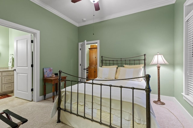 bedroom featuring crown molding, baseboards, light colored carpet, and connected bathroom