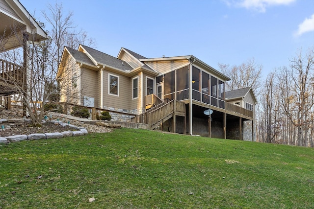 rear view of house featuring a sunroom, a lawn, and stairs