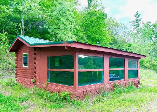 view of outbuilding with a view of trees