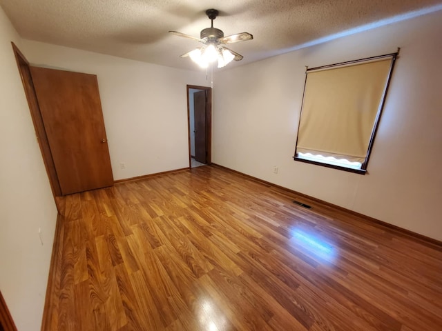 188 Bradford Hill Rd N, Brush Creek, TN 38547 - unfurnished bedroom featuring visible vents, a textured ceiling, and light wood-style flooring