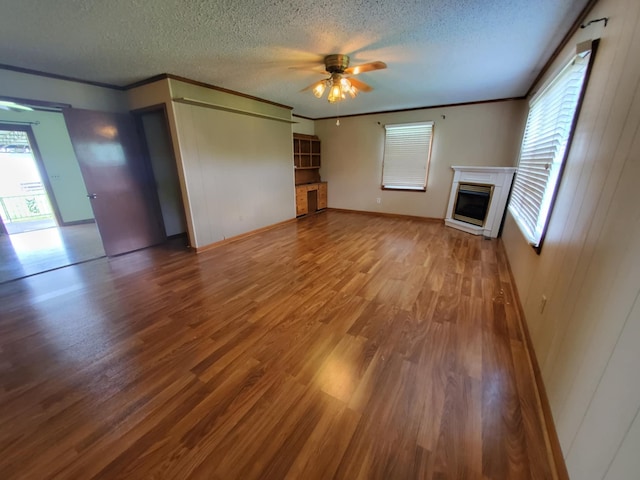 188 Bradford Hill Rd N, Brush Creek, TN 38547 - unfurnished living room with a ceiling fan, a textured ceiling, plenty of natural light, and wood finished floors