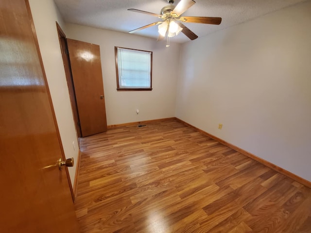 188 Bradford Hill Rd N, Brush Creek, TN 38547 - unfurnished bedroom featuring light wood-style floors, baseboards, and ceiling fan