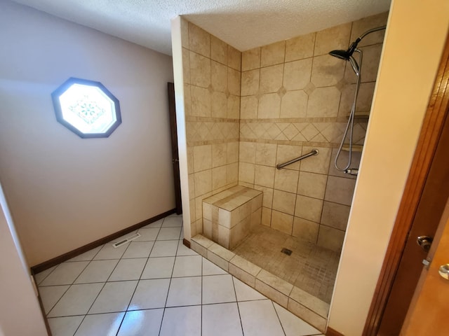 188 Bradford Hill Rd N, Brush Creek, TN 38547 - full bath featuring baseboards, a textured ceiling, tile patterned floors, and a tile shower