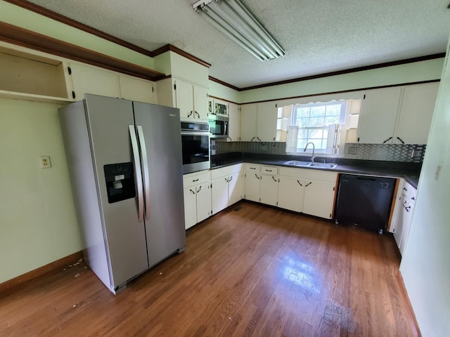 188 Bradford Hill Rd N, Brush Creek, TN 38547 - kitchen featuring a sink, a textured ceiling, appliances with stainless steel finishes, and dark countertops