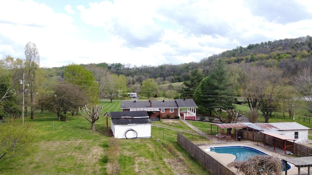 188 Bradford Hill Rd N, Brush Creek, TN 38547 - view of pool with fence, a fenced in pool, an outbuilding, and a wooded view