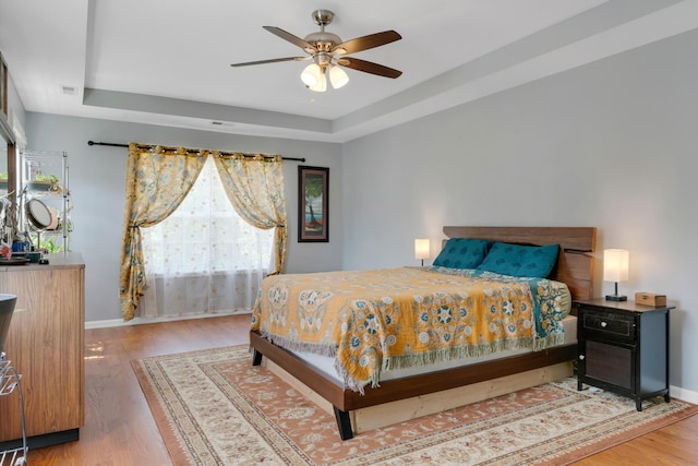 1244 Baker Creek Dr, Spring Hill, TN 37174 - bedroom with a tray ceiling, baseboards, and wood finished floors