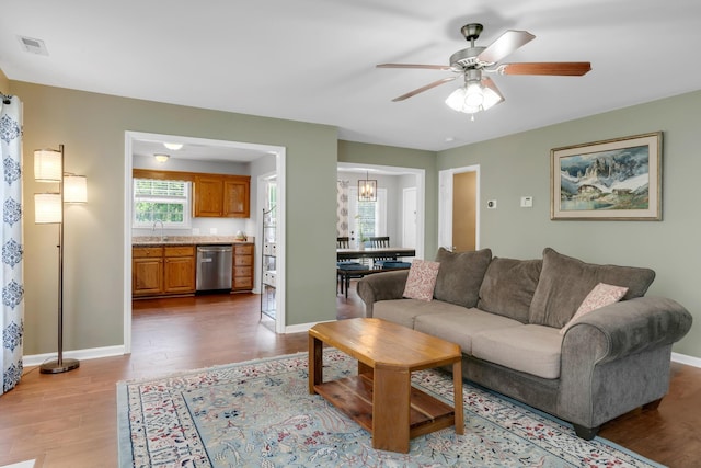 1244 Baker Creek Dr, Spring Hill, TN 37174 - living room with baseboards, visible vents, wood finished floors, and ceiling fan with notable chandelier