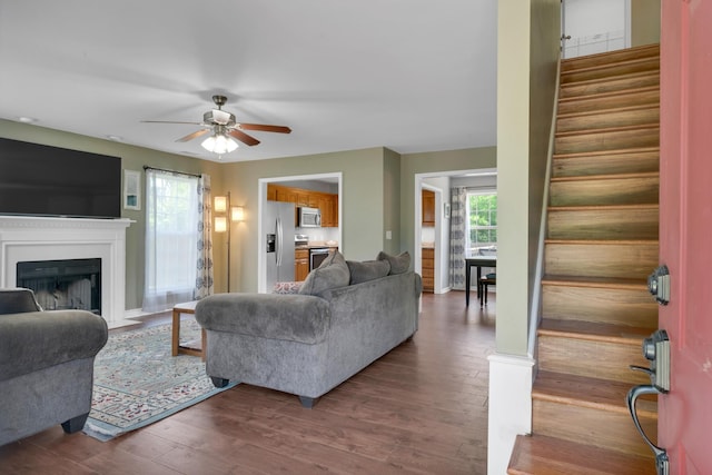 1244 Baker Creek Dr, Spring Hill, TN 37174 - living room featuring stairway, ceiling fan, a fireplace with flush hearth, and wood finished floors