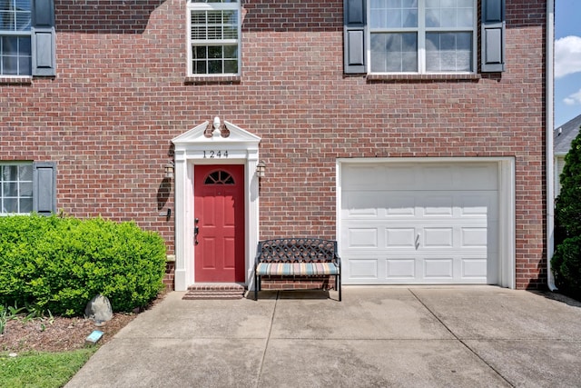 1244 Baker Creek Dr, Spring Hill, TN 37174 - entrance to property featuring brick siding, a garage, and concrete driveway