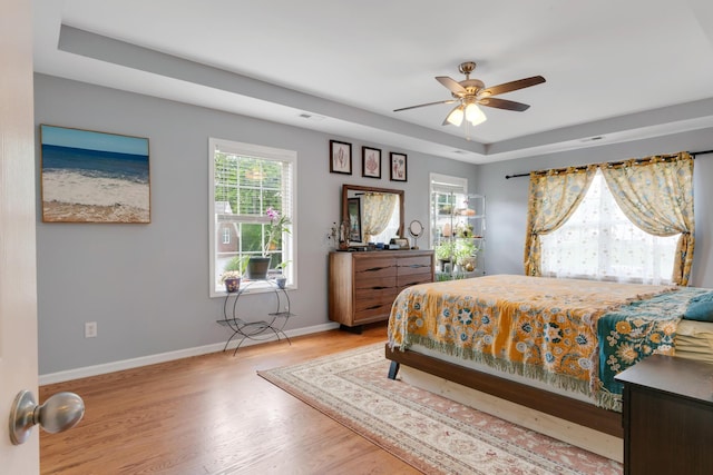 1244 Baker Creek Dr, Spring Hill, TN 37174 - bedroom featuring ceiling fan, a raised ceiling, light wood-style floors, baseboards, and visible vents