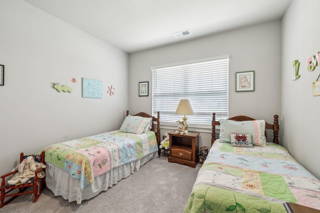 carpeted bedroom featuring visible vents